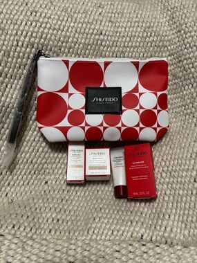 Shiseido Red & White Geometric Cosmetic Pouch with four new products included.